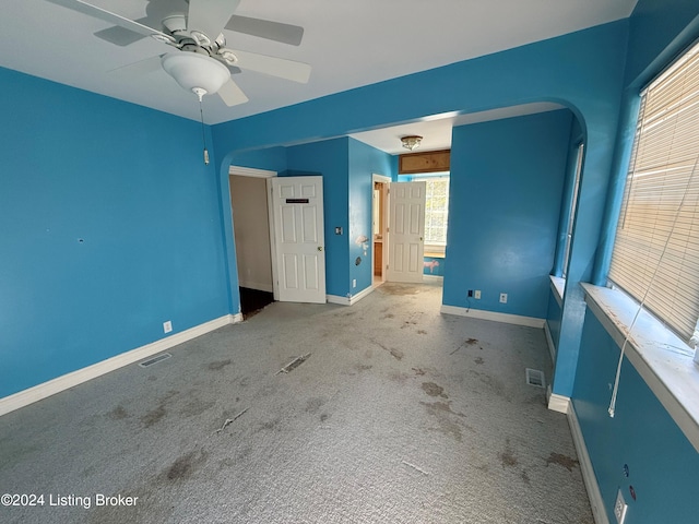 unfurnished bedroom with carpet floors and ceiling fan