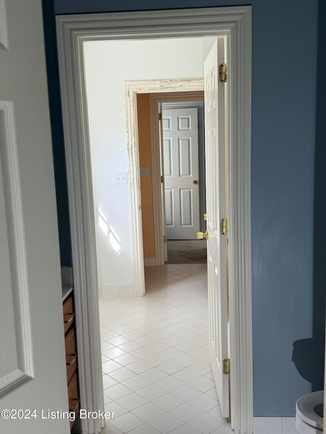 hall featuring light tile patterned floors