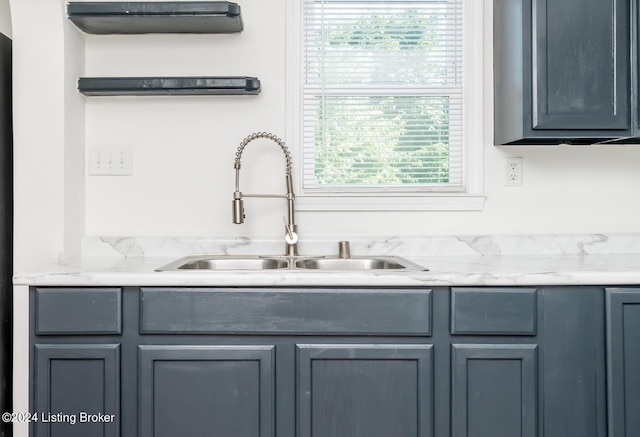 interior space with gray cabinets and sink