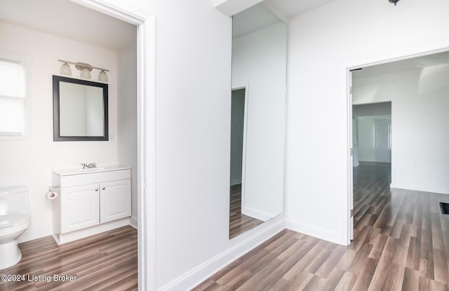 hallway with sink and hardwood / wood-style floors