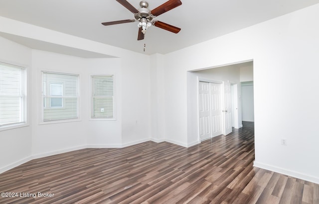 spare room featuring dark hardwood / wood-style flooring and ceiling fan