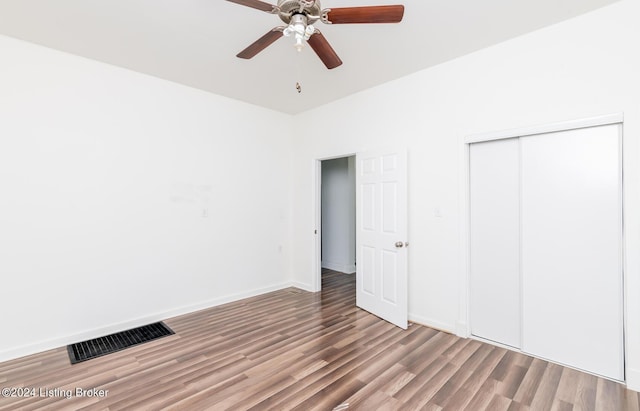 unfurnished bedroom featuring wood-type flooring, a closet, and ceiling fan