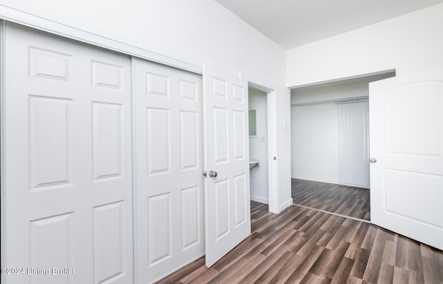 unfurnished bedroom featuring a closet and dark hardwood / wood-style floors