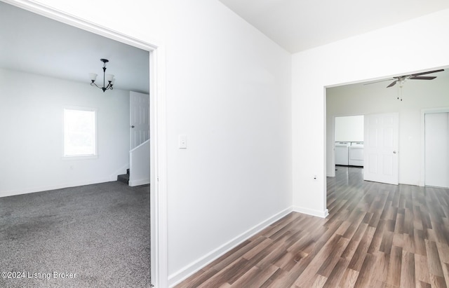 corridor with independent washer and dryer and an inviting chandelier