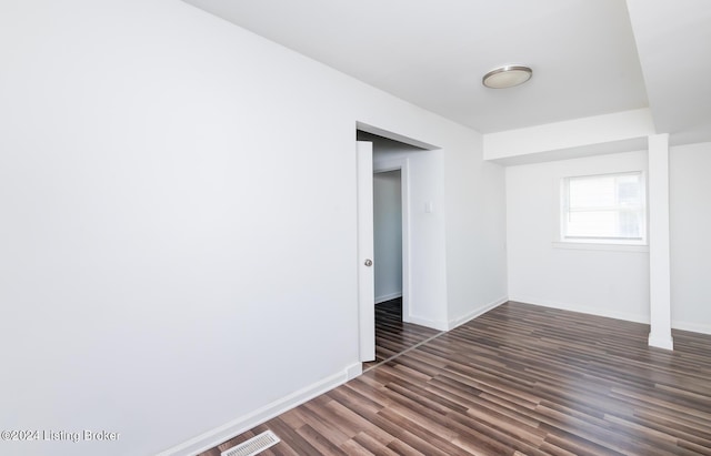 empty room featuring dark hardwood / wood-style flooring