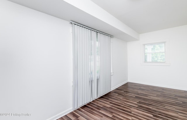 spare room featuring dark hardwood / wood-style flooring