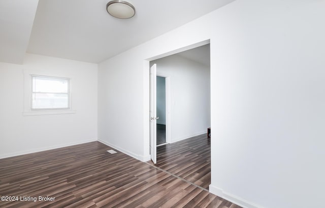 empty room with dark wood-type flooring