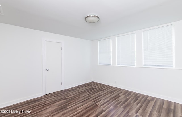 empty room with dark wood-type flooring