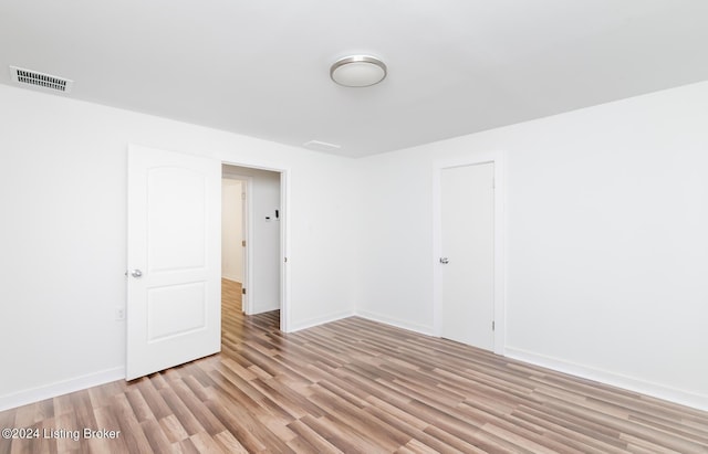 spare room with light hardwood / wood-style flooring