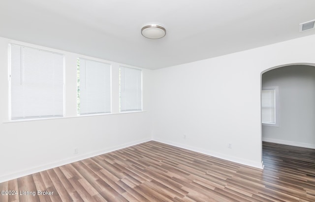 unfurnished room with wood-type flooring