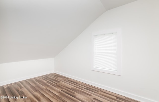 bonus room featuring vaulted ceiling and hardwood / wood-style floors