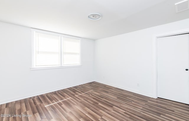 unfurnished room with dark hardwood / wood-style floors