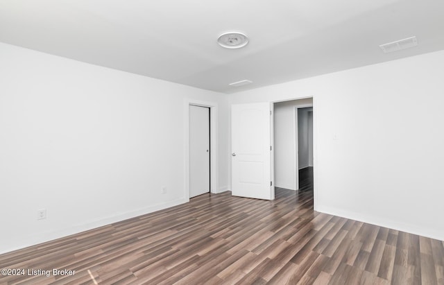 empty room featuring dark hardwood / wood-style flooring