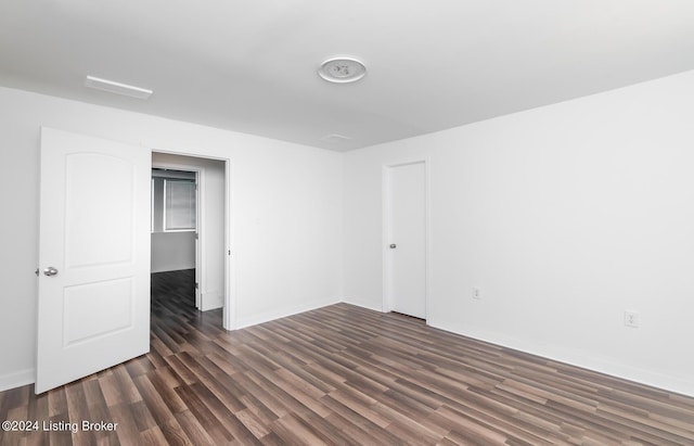 unfurnished room featuring dark hardwood / wood-style flooring