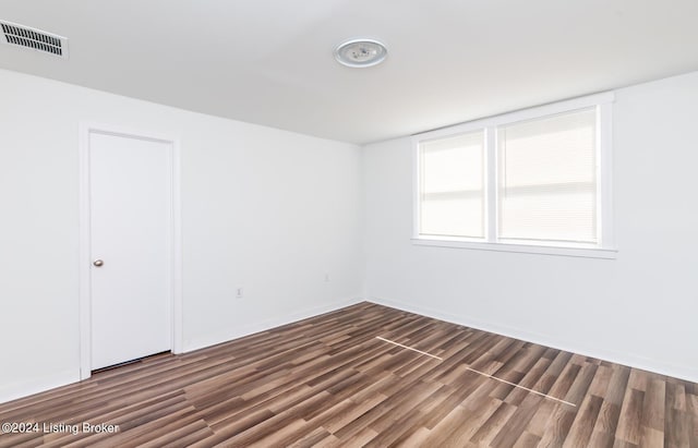 empty room featuring dark wood-type flooring