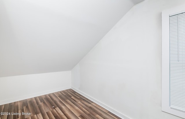 bonus room with lofted ceiling and dark hardwood / wood-style floors