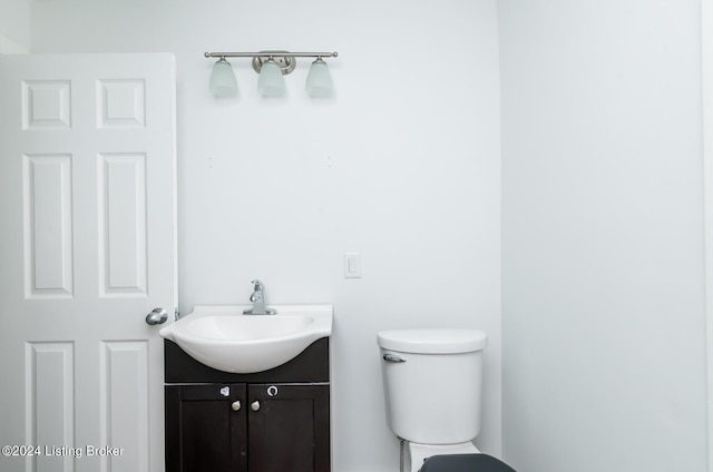 bathroom featuring toilet and vanity