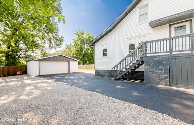 view of side of property with a garage and an outbuilding