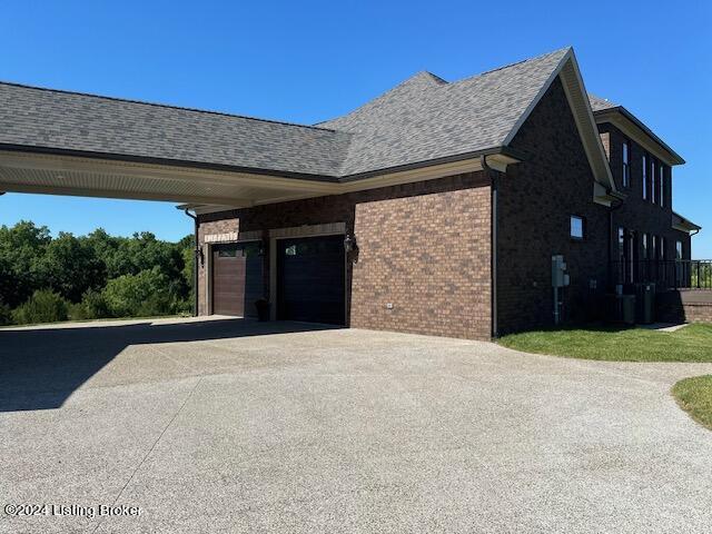 view of home's exterior featuring a garage and a carport