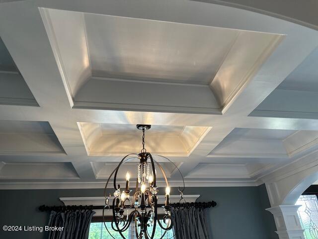 room details with beam ceiling, crown molding, an inviting chandelier, and coffered ceiling