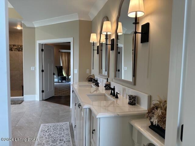 bathroom with ornamental molding, tile patterned flooring, and vanity