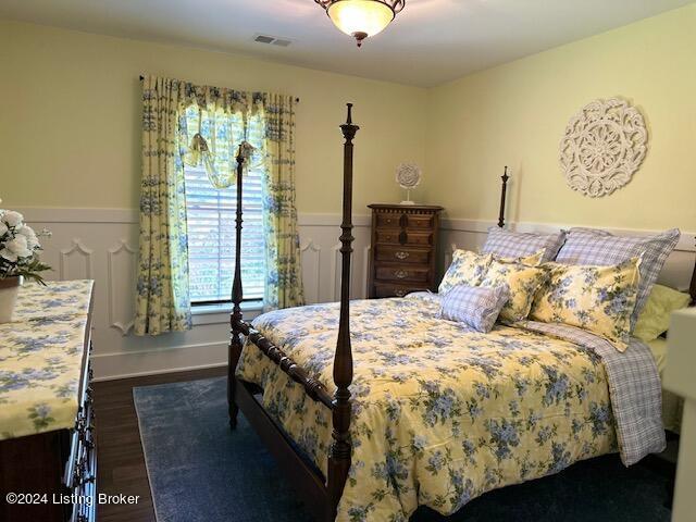 bedroom with dark hardwood / wood-style floors