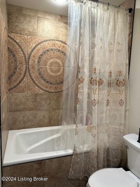 bathroom with toilet and shower / tub combo with curtain