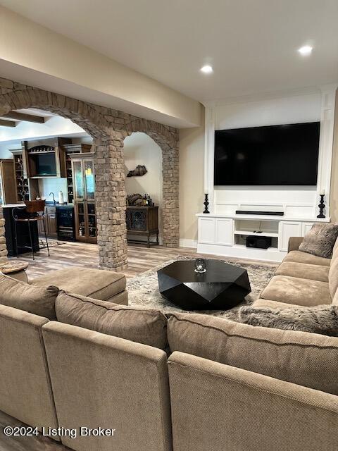 living room featuring hardwood / wood-style flooring and bar area