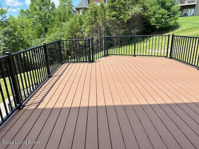 wooden deck featuring a yard