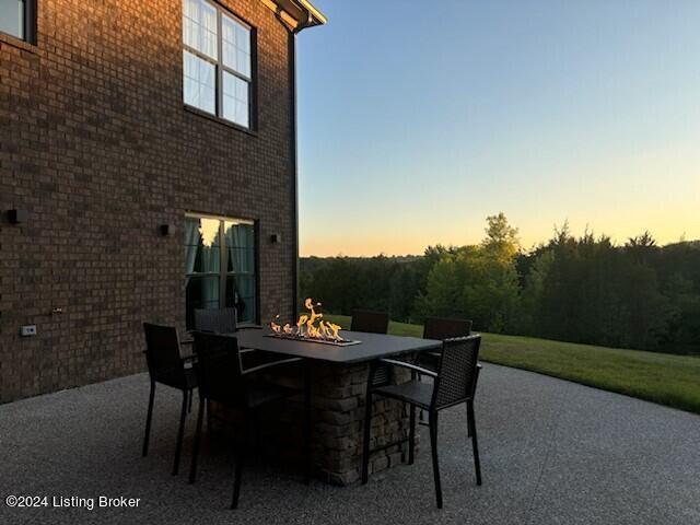 patio terrace at dusk featuring an outdoor fire pit