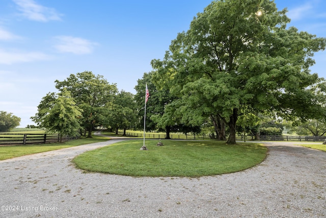 view of property's community featuring a yard and a rural view