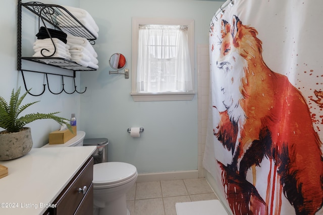 bathroom with tile patterned flooring, vanity, and toilet