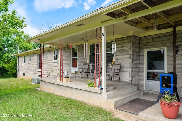 entrance to property with a yard and a porch