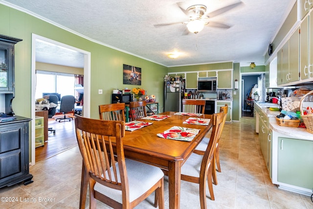 dining space with crown molding, ceiling fan, and a textured ceiling