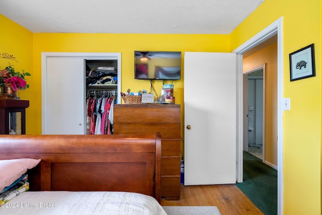 bedroom with light wood-type flooring and a closet