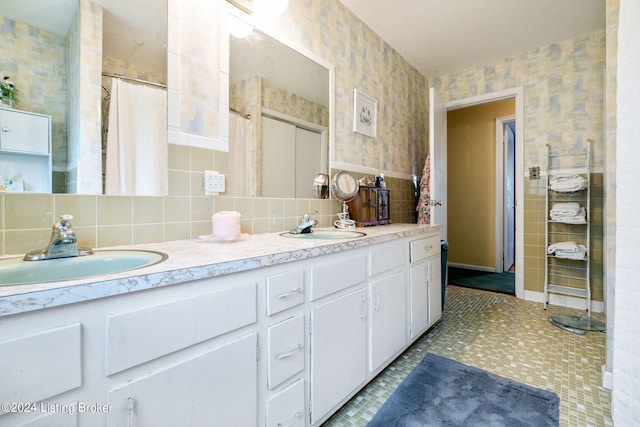 bathroom with vanity, curtained shower, tile patterned floors, and decorative backsplash