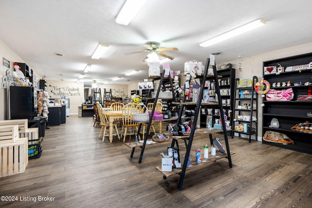 interior space featuring a textured ceiling, wood-type flooring, and ceiling fan