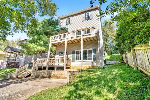 rear view of property with central AC, a lawn, and a wooden deck