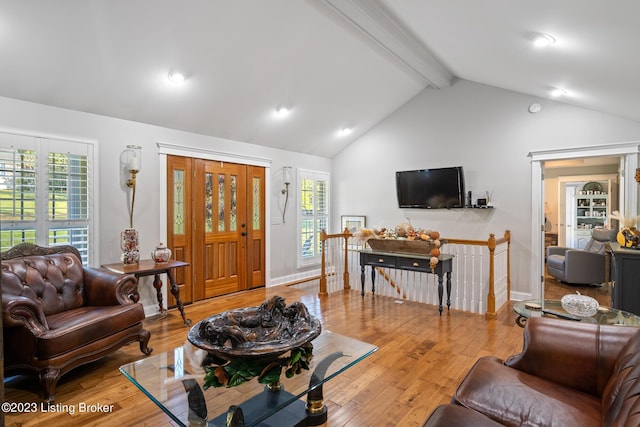 living room featuring high vaulted ceiling, beamed ceiling, and light wood-type flooring