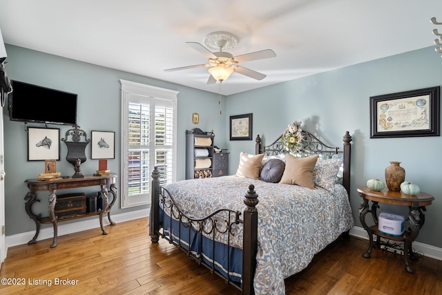 bedroom with wood-type flooring and ceiling fan