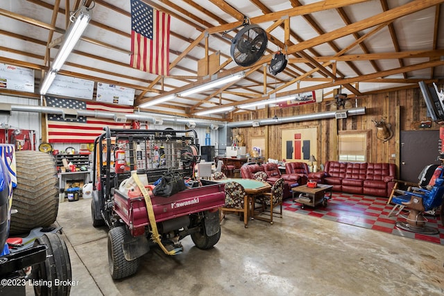 garage featuring wooden walls and a workshop area