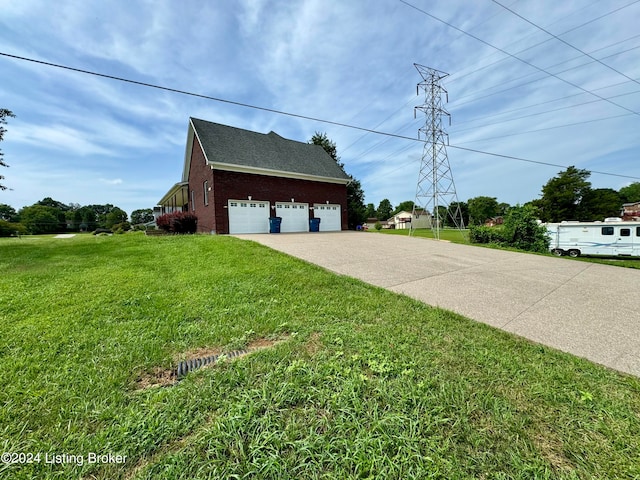 view of side of home with a garage and a lawn