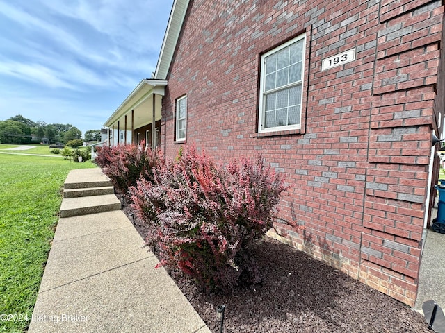 view of property exterior with a lawn