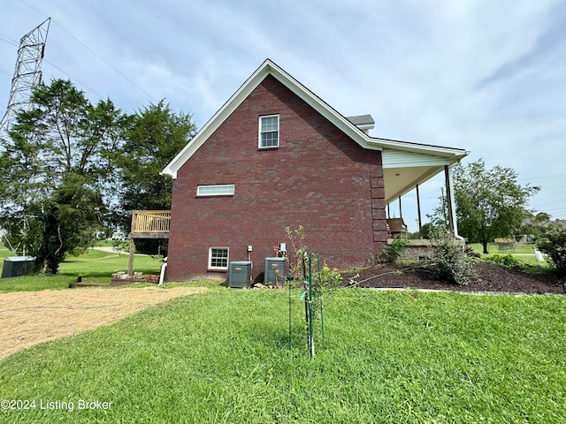 view of property exterior featuring central AC unit and a lawn