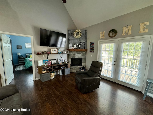 living room featuring french doors, brick wall, a fireplace, wood-type flooring, and high vaulted ceiling