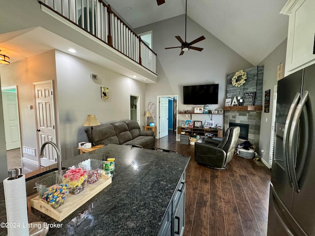 kitchen featuring ceiling fan, dark hardwood / wood-style flooring, white cabinets, high vaulted ceiling, and refrigerator with ice dispenser