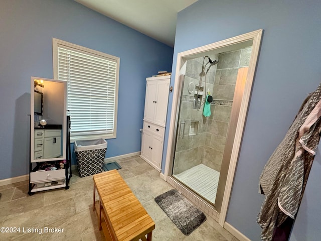 bathroom featuring a shower with shower door and tile patterned floors