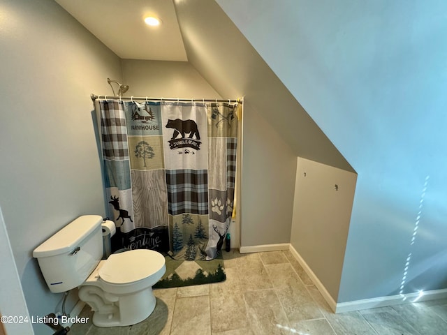 bathroom with tile patterned flooring, lofted ceiling, and toilet