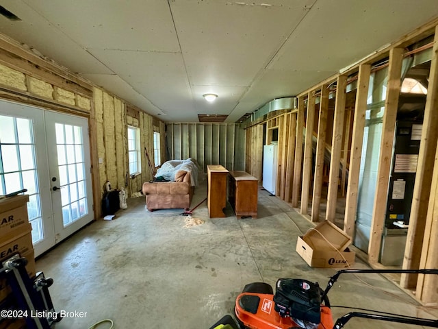 interior space featuring french doors and concrete floors