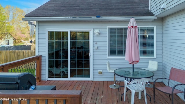 wooden deck featuring a grill